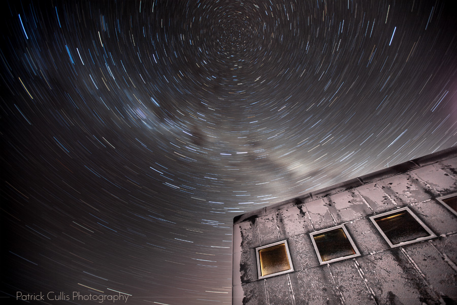 The Amundsen-Scott South Pole Station and stars swirl in a 15 minute exposure at night.